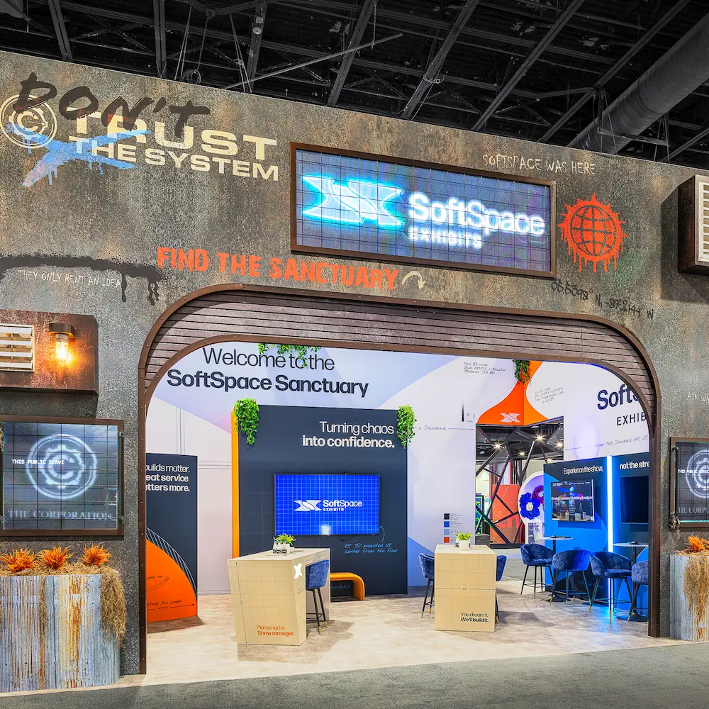 A custom trade show booth designed by SoftSpace Exhibits featuring the 'SoftSpace Sanctuary' theme and 'Turning chaos into confidence' display, highlighting stress-free, full-service event management.