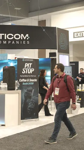 A trade show attendee walking past an interactive coffee and snacks booth structure designed by SoftSpace Exhibits to engage crowds at major events.